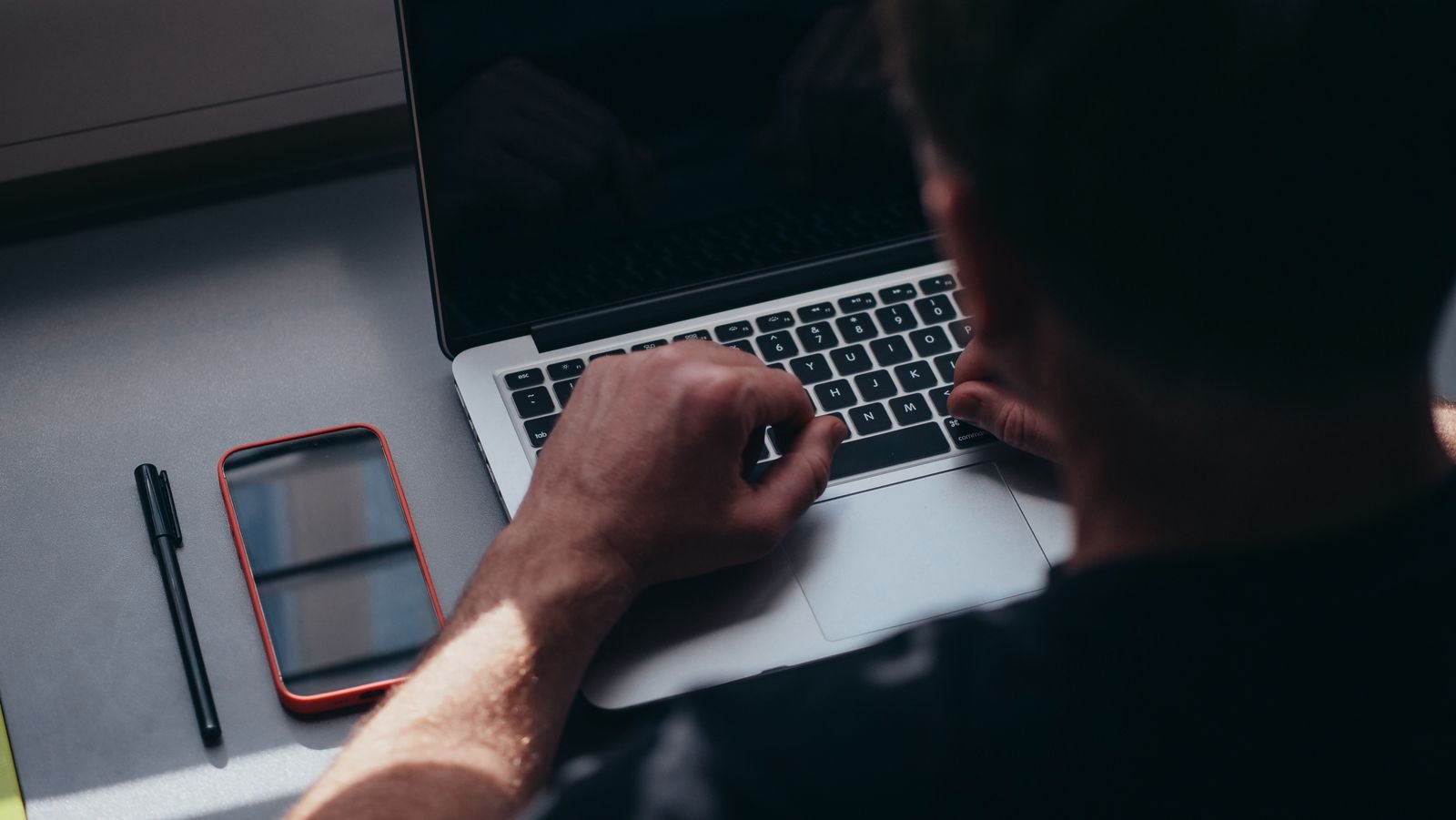 Person working at a desk with a laptop